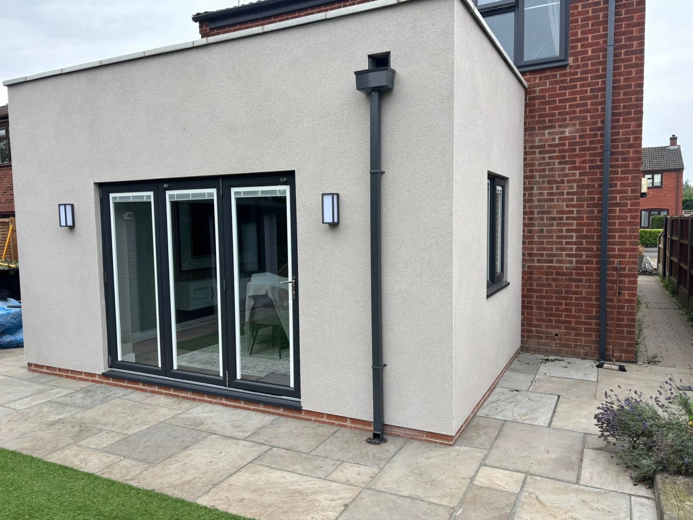 Rendered rear extension with bi-fold doors